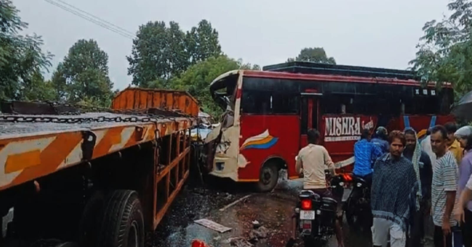 Severely damaged bus and trailer after Dhanbad road accident near Kamalpur